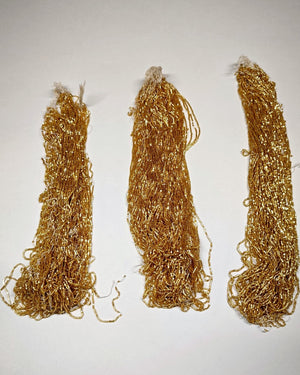 Three hanks of gold silver-lined tubes, Norman Hartnell archive