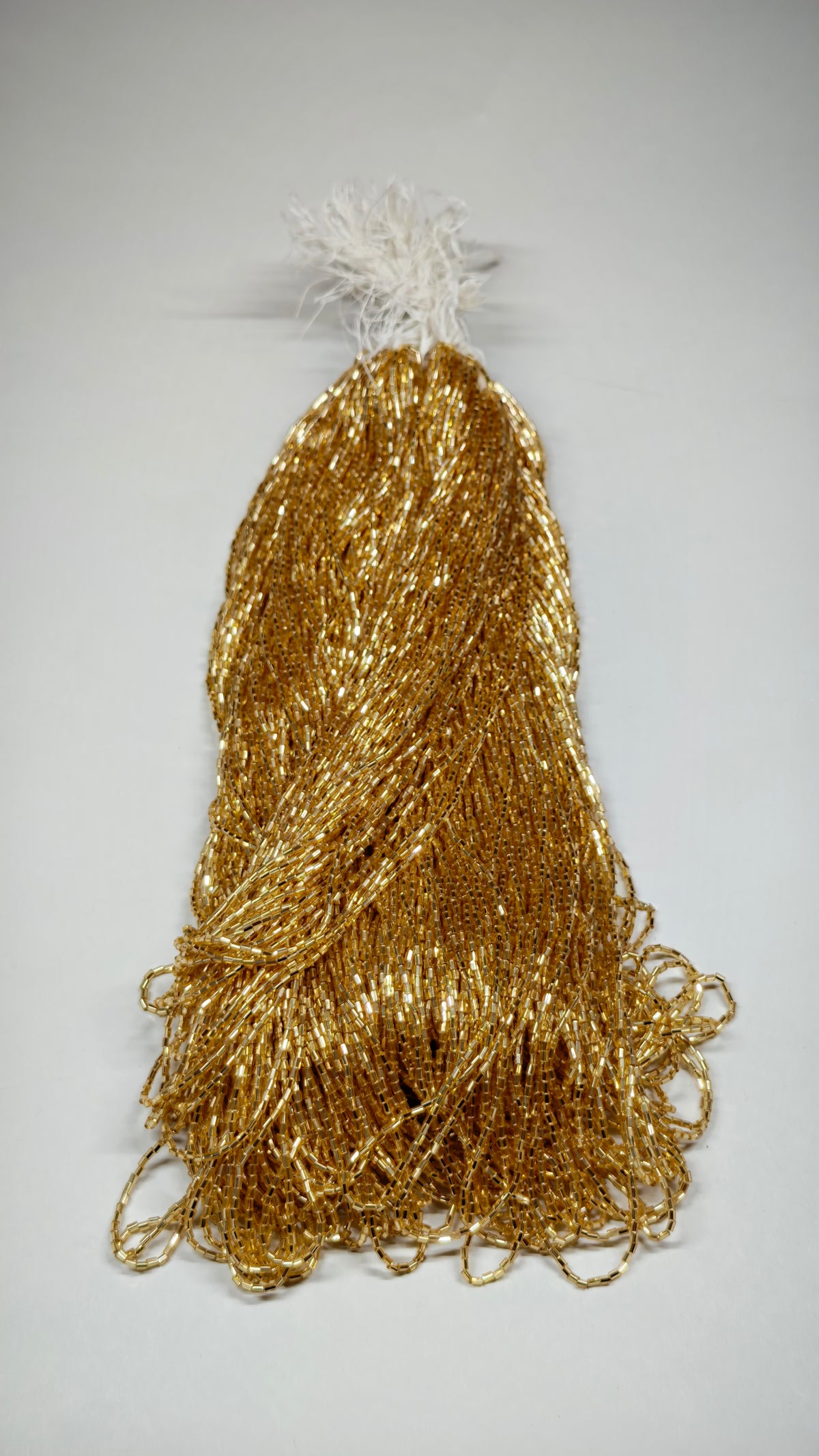 Hank of gold silver-lined bugle beads for embroidery