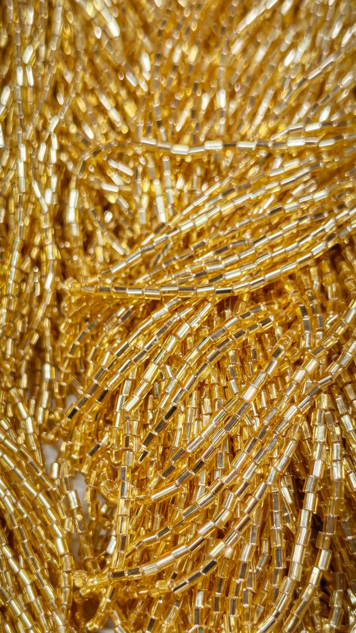 Close-up of gold silver-lined Czech glass tubes