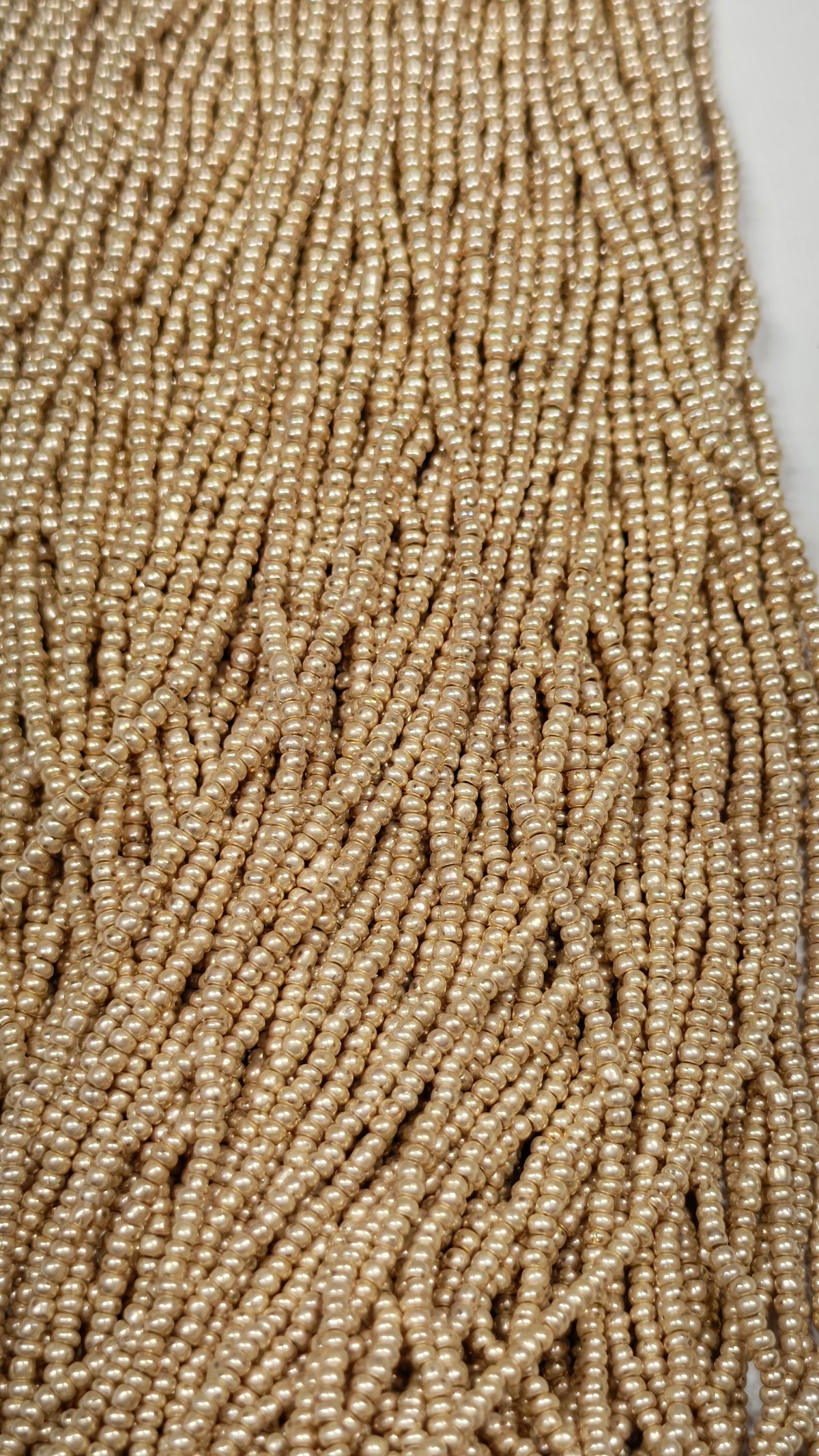 Close-up of pale gold satin seed beads