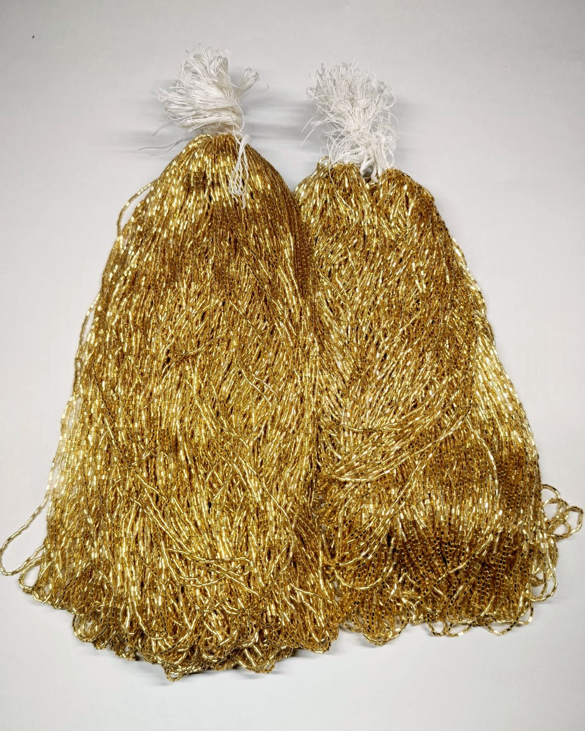 Two hanks of gold silver-lined Czech glass tubes
